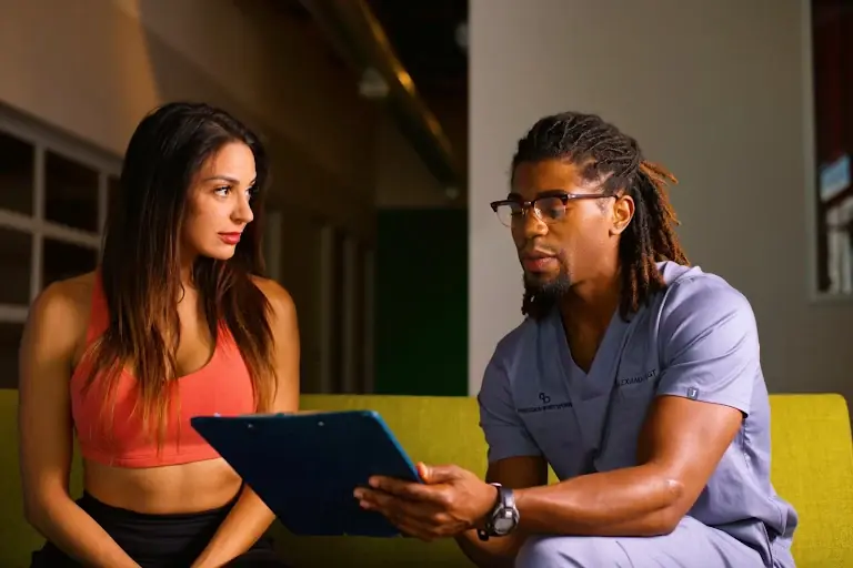 Therapist reviewing intake notes with a client before her first session