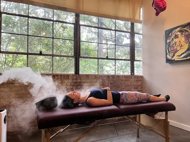 Client resting calmly during a trauma-informed nervous system reset with P.E.M.F. therapy at PreBodyworks